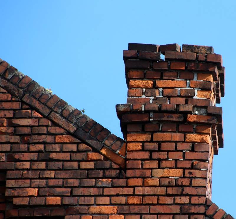 Damaged chimney on an Ida home showing cracks and missing mortar